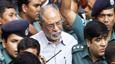 This November 25 photo shows police escorting Abdul Latif Siddique to a Dhaka court around 40 minutes after his surrender at Dhanmondi Police Station.