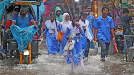 Students wade through submerged streets of the capital. 