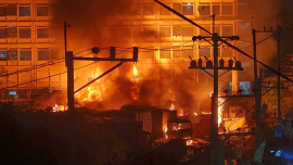 The fire broke out in the open parking area in front of the factories, which is used by vehicles transporting goods from the factories. Photo: Collected