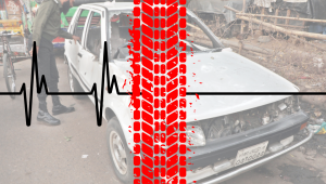 Smeared out print of a tyre against a backdrop of a wrecked vehicle 