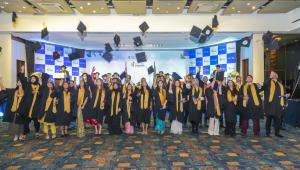 Students throwing their mortarboards up.  
