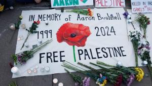 People leave notes and flowers during a vigil for US Air Force active-duty airman Aaron Bushnell outside the Israeli Embassy on February 26, 2024 in Washington, DC.