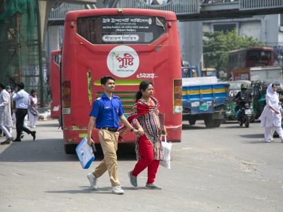 Student crossing the street with parent.